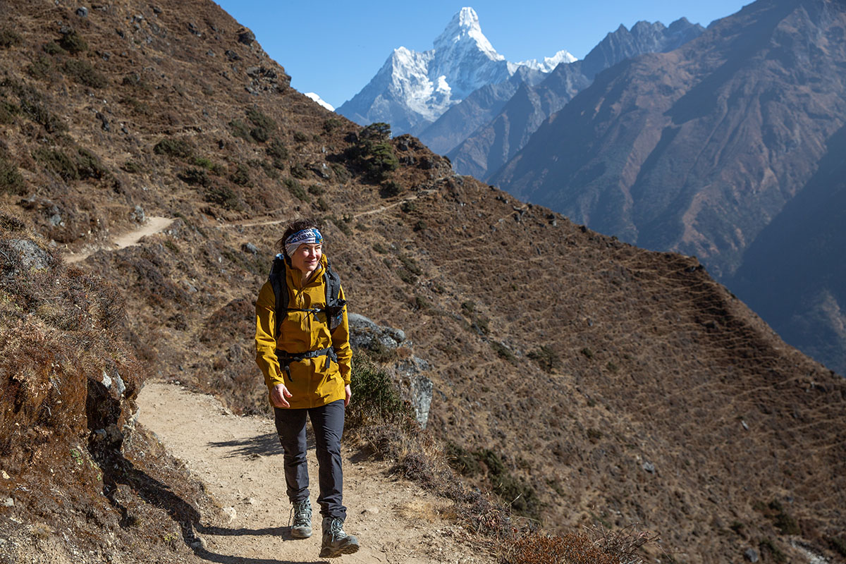 A woman hikes near Ama Dablam in Nepal with a pair of hiking boots