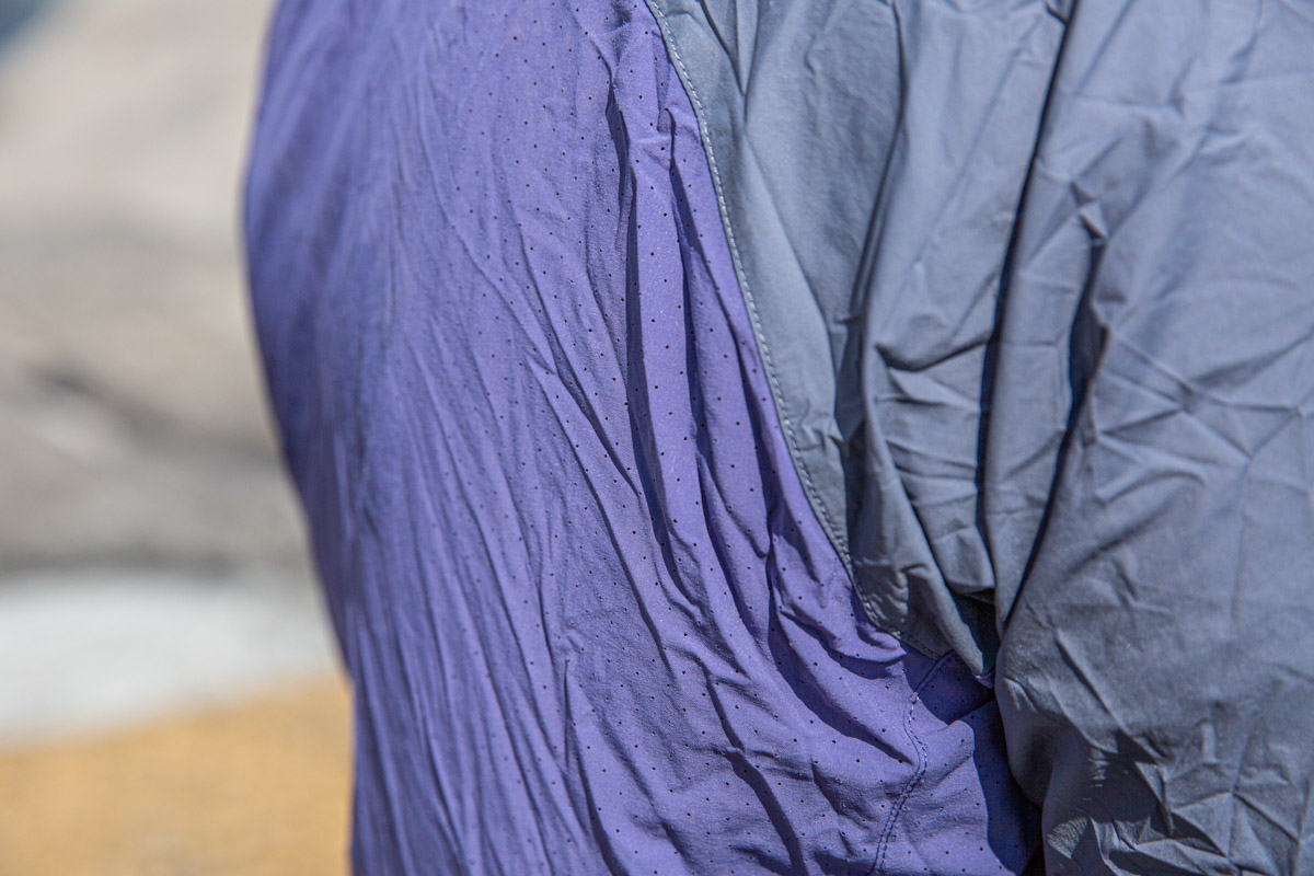 A close up of the back of a blue windbreaker