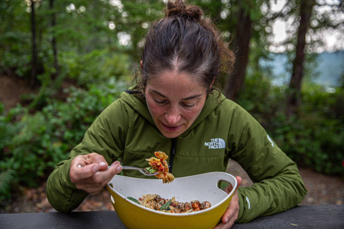 A woman eating in a synthetic jacket