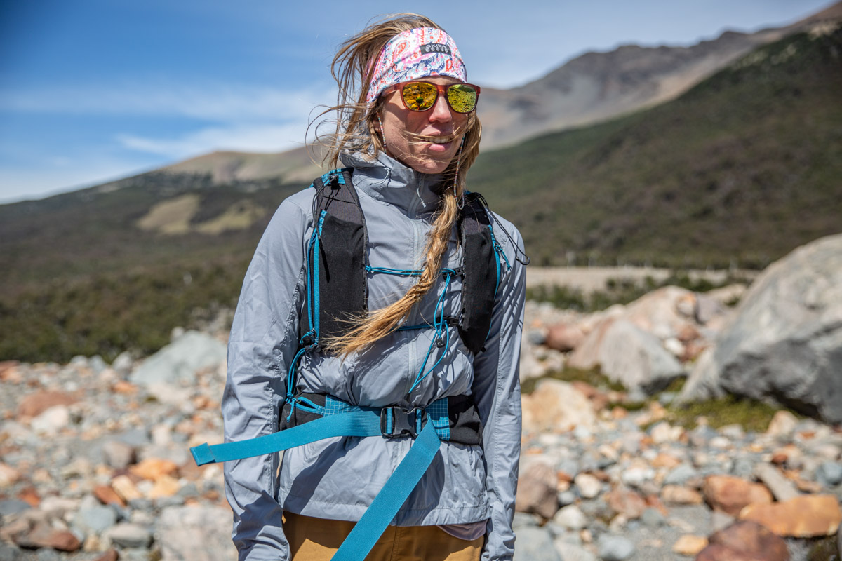 A woman wearing a windbreaker in the wind