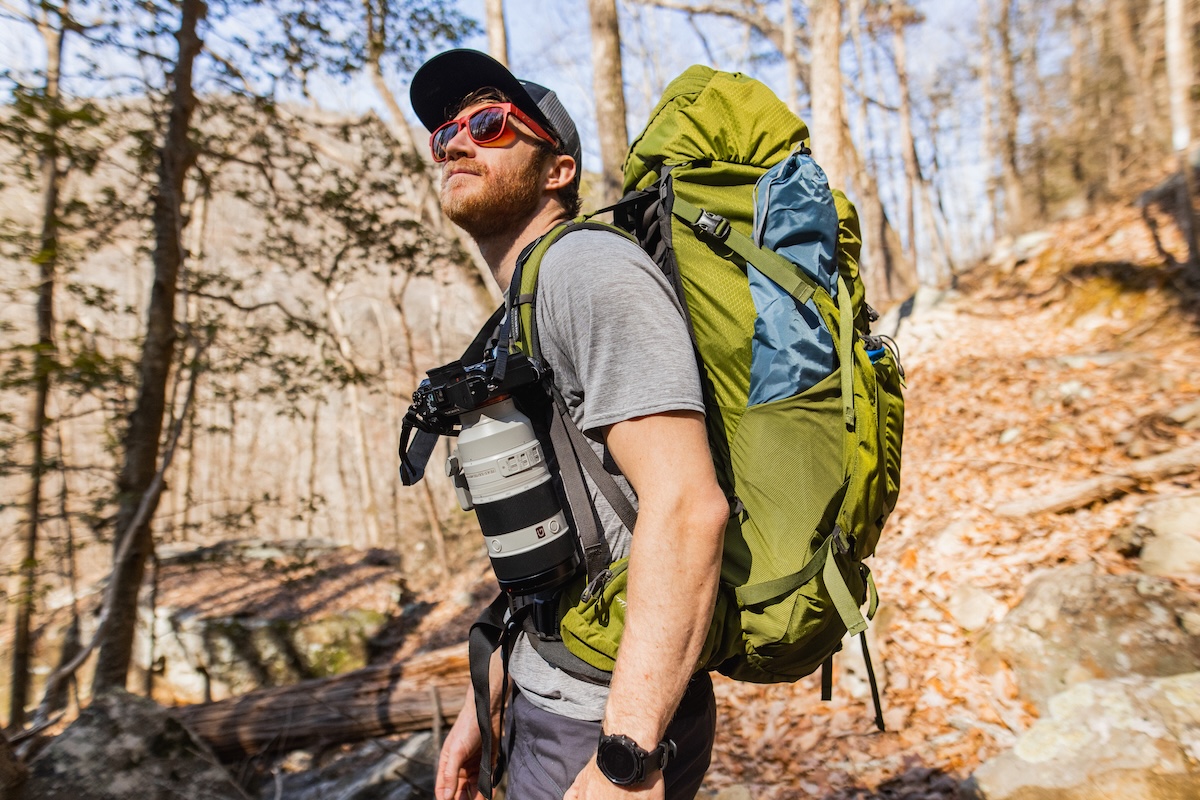A man backpacking with a chonker Sony camera
