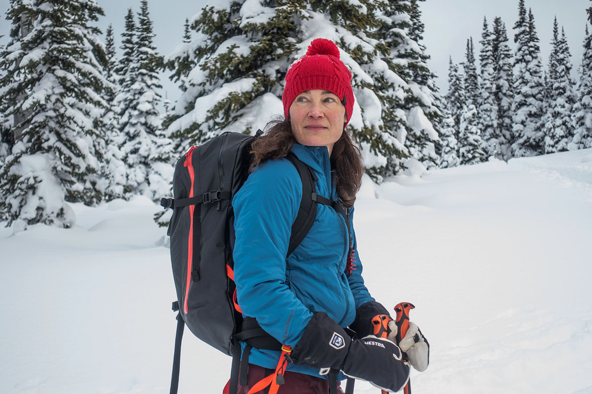 A woman standing in the snow in a synthetic jacket