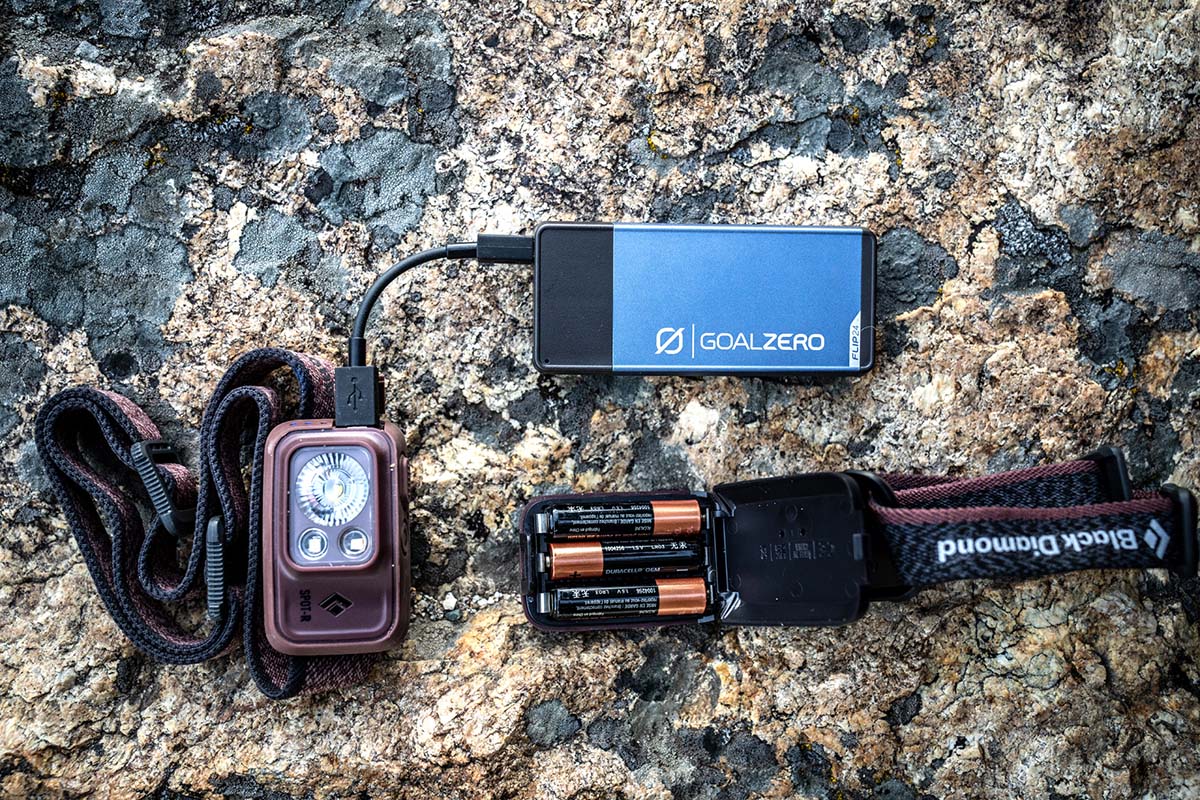 A headlamp plugged into a power bank