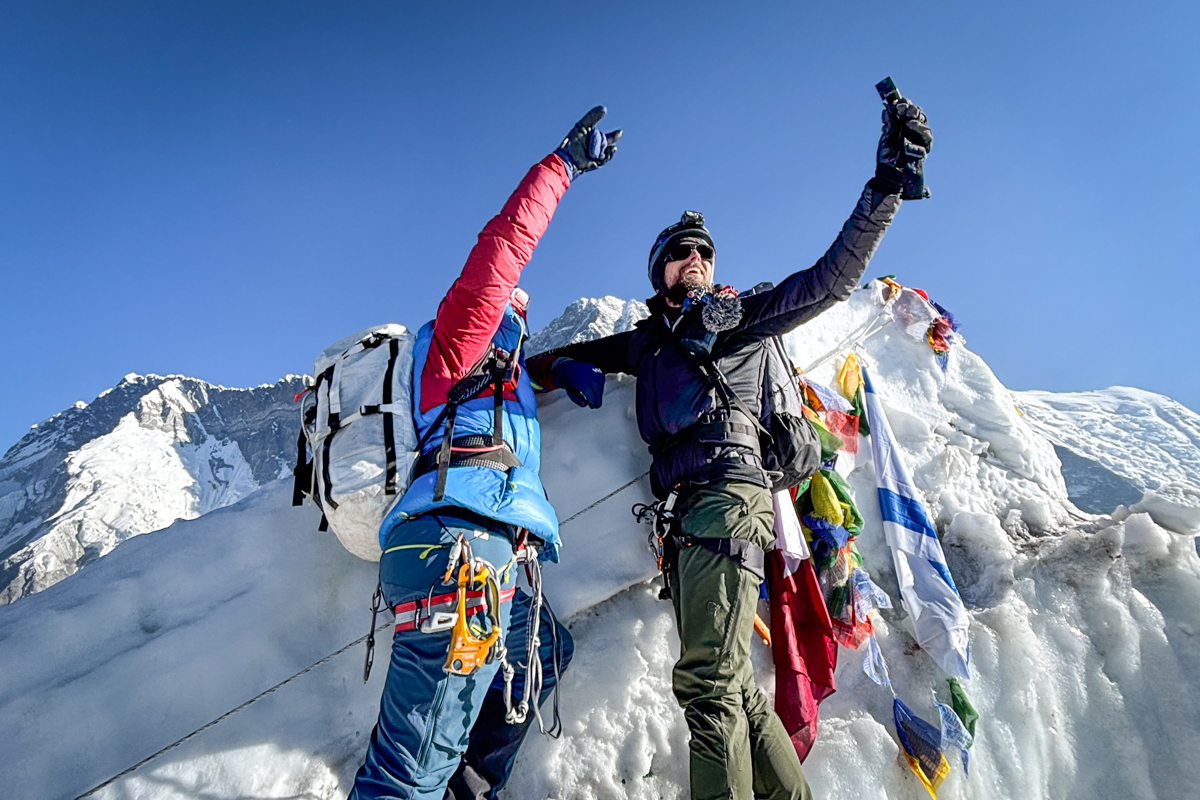 Two men taking a selfie on top of a mountain in Nepal