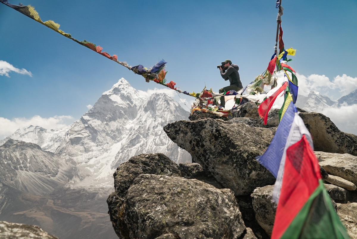 A man taking a video of mountains in Nepal