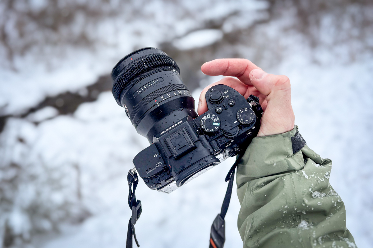 A closeup of a camera with water drops on it