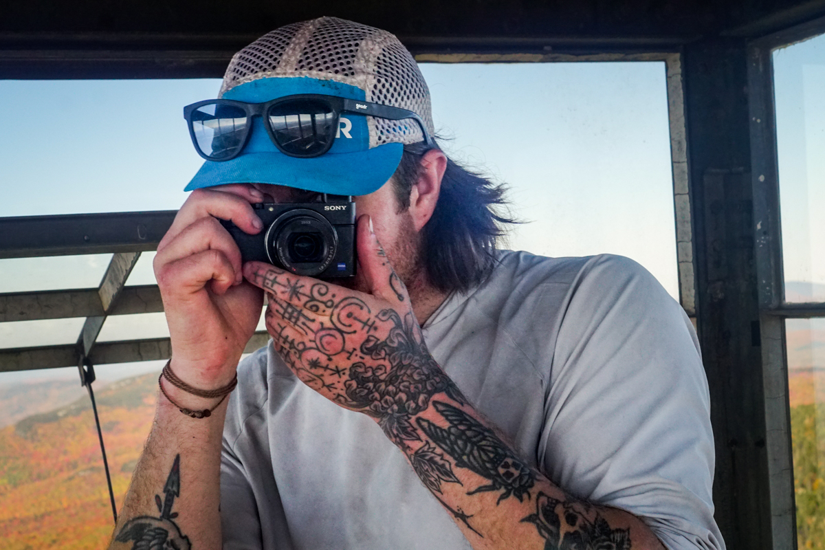 A man takes a photo with a Sony camera