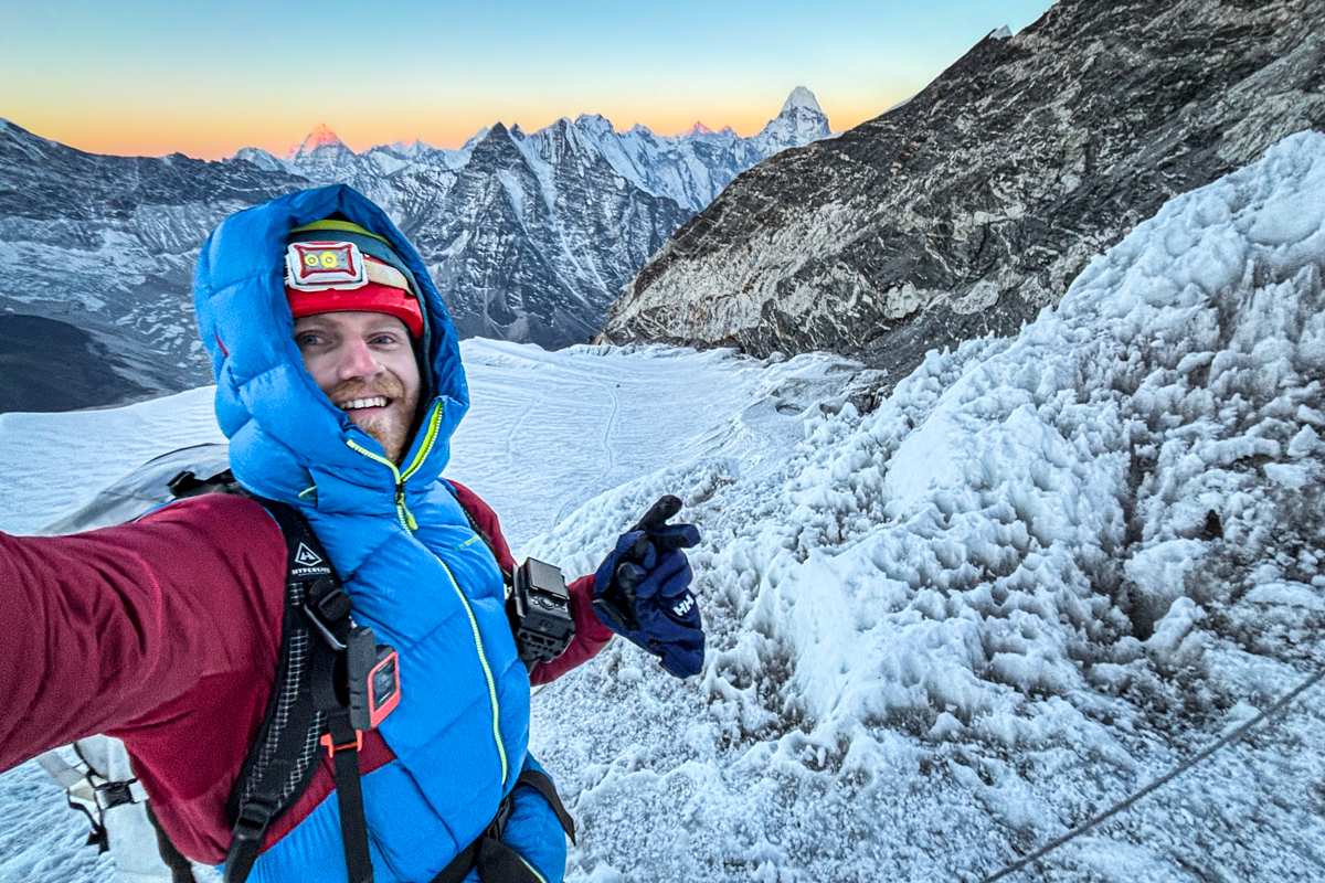 A man climbing a mountain with a Sony camera