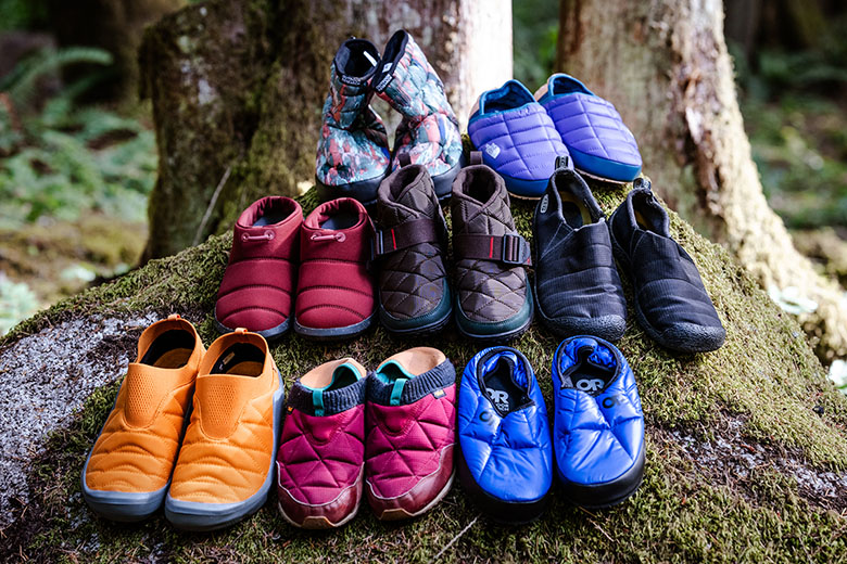 A group of camp shoes sitting together on a rock