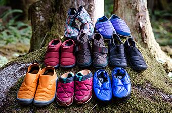 A group of camp shoes sitting together on a rock