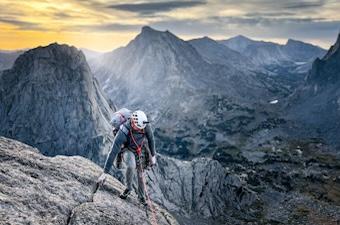 A man rock climbing in the mountains in Wyoming