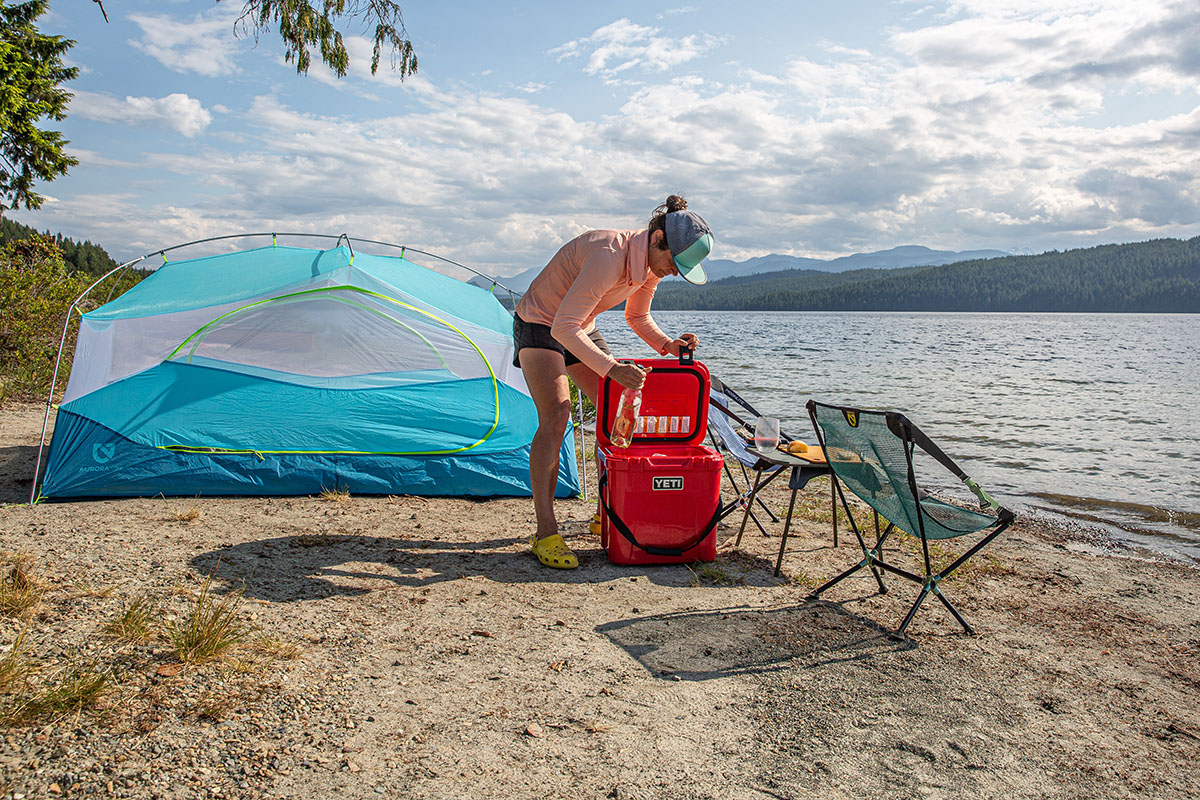 A woman pulling drinks out of a cooler