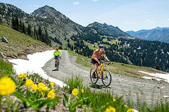 A bike rider takes their gravel bike down a mountain path. 