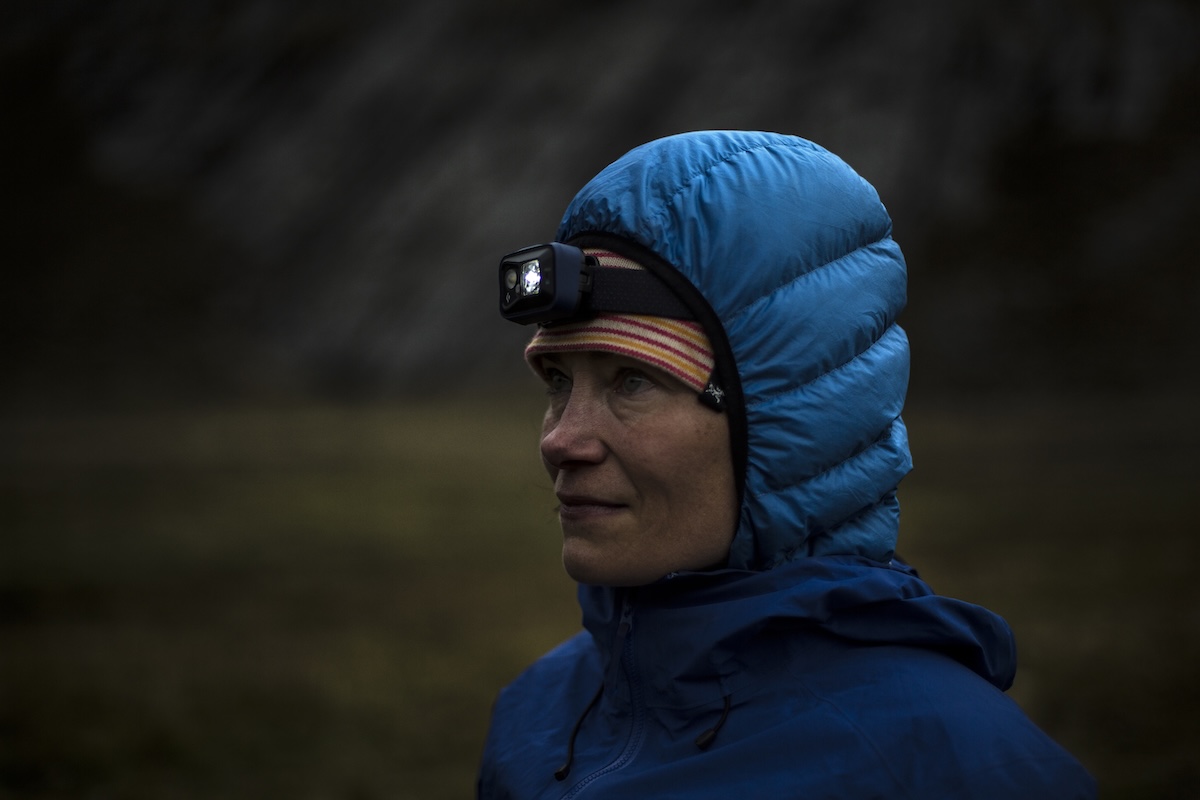 A woman wearing a headlamp