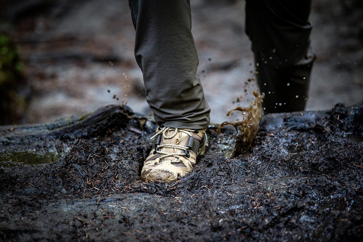 A closeup shot of stepping in deep mud with Salomon Quest 4