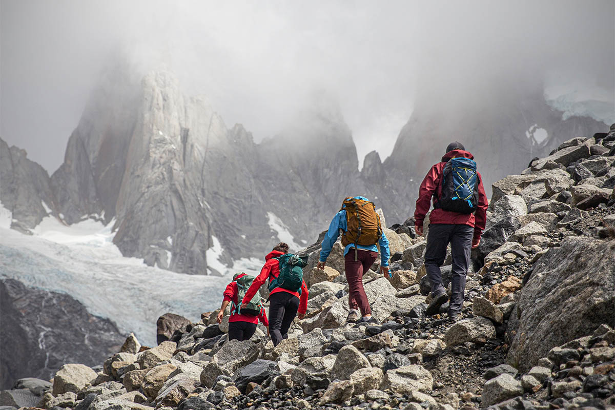 A group of hikers trek into foggy mountain peaks