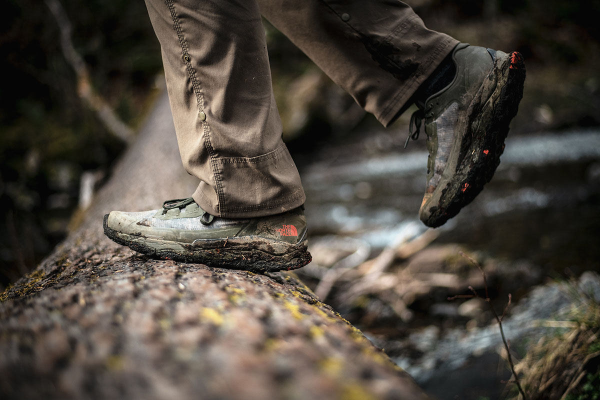 A close up of waterproof hiking shoes caked in mud
