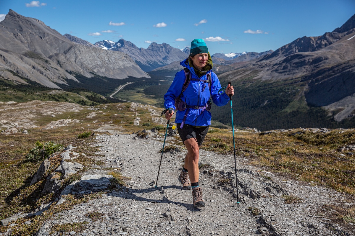 A woman hikes near a beautiful overlook in hiking boots