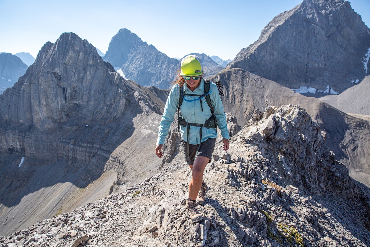 A hiker on a narrow mountain crest.