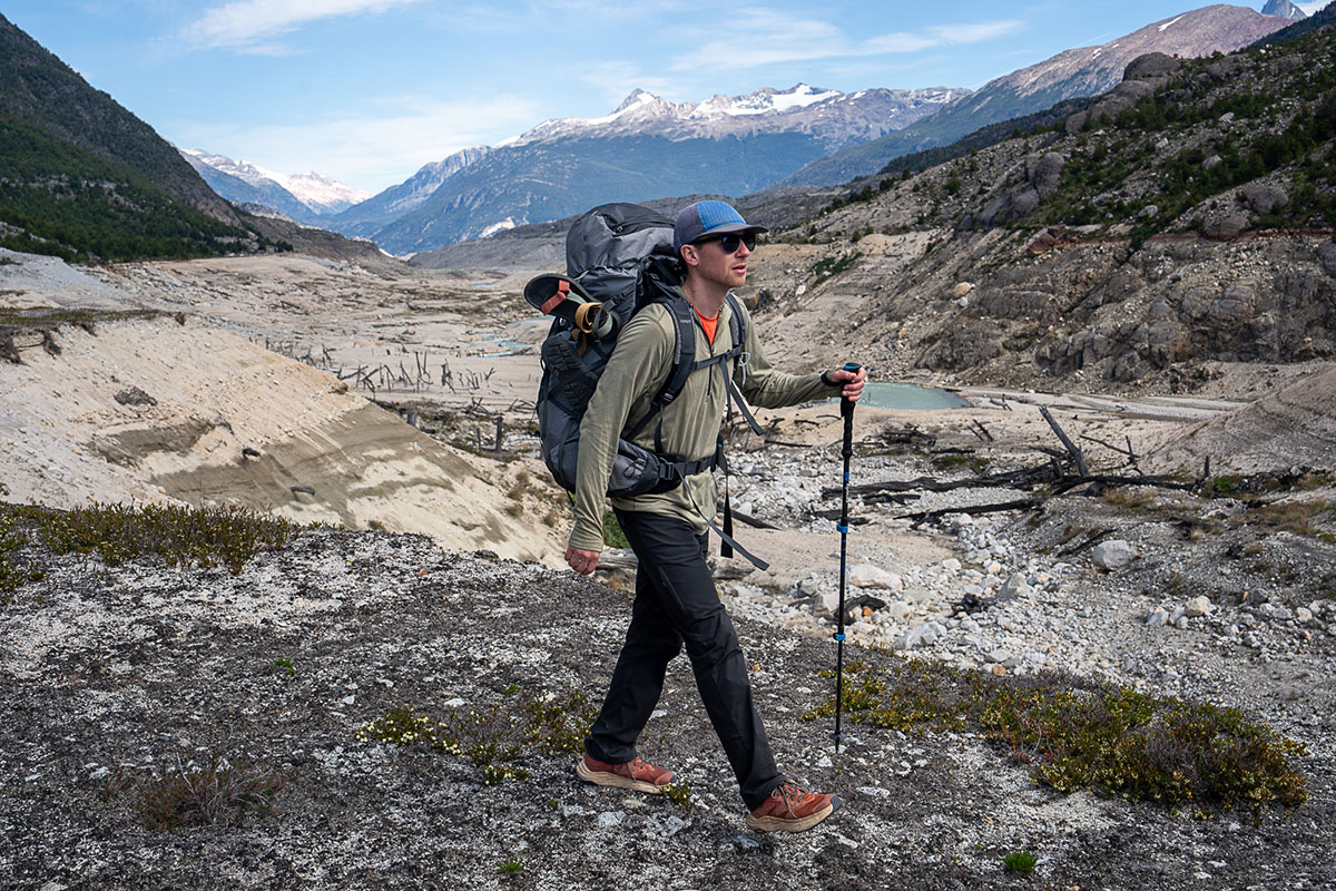 A man backpacks with the Hoka Anacapa 2 Mid GTX boots