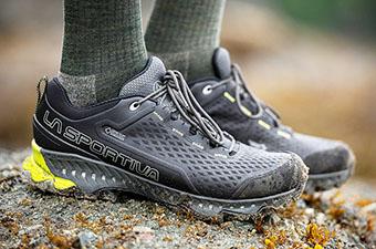 The La Sportiva Spire posed on a rock. 