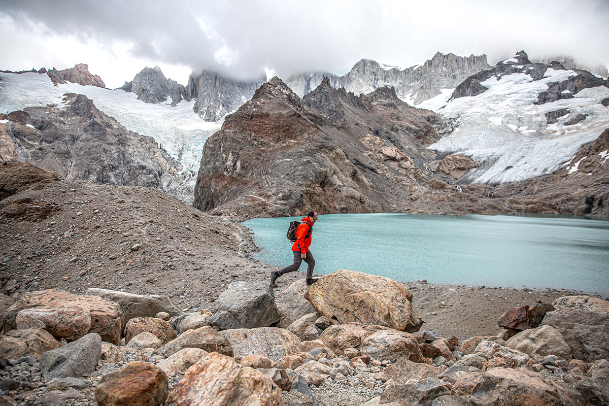 A man hikes near a lake in the La Sportiva Ultra Raptor II Mid GTX hiking boot