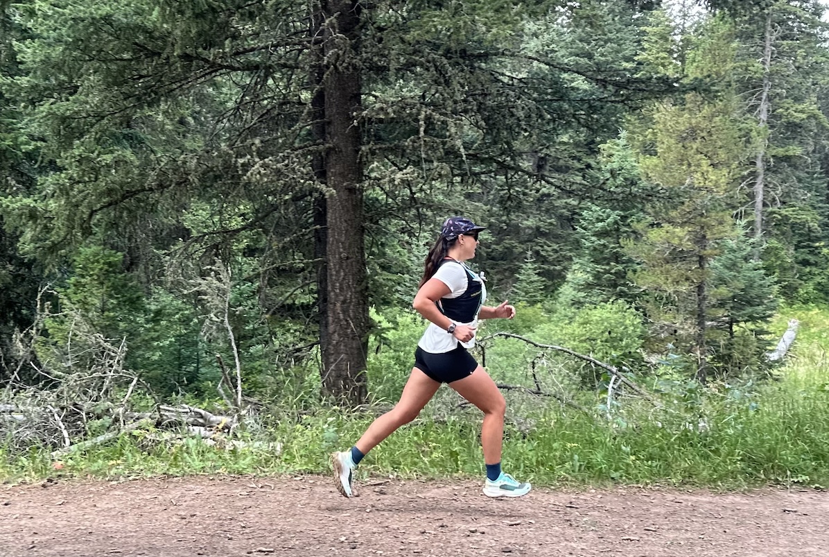 a woman running through the woods