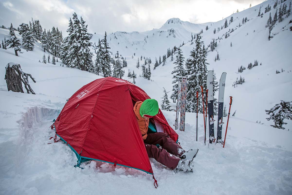 A skier coming out of the Mountain Hardwear Trango 2 4-season mountaineering tent