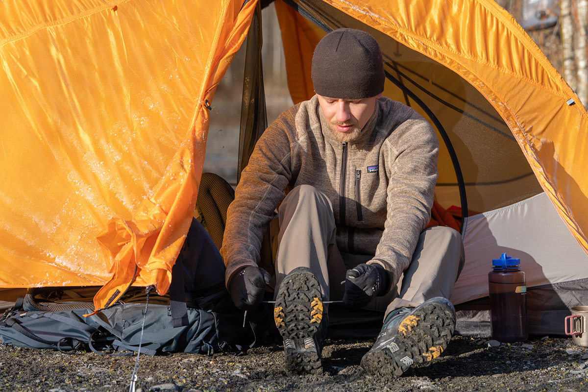 A man ties the Salomon X Ultra 4 Mid hiking boot