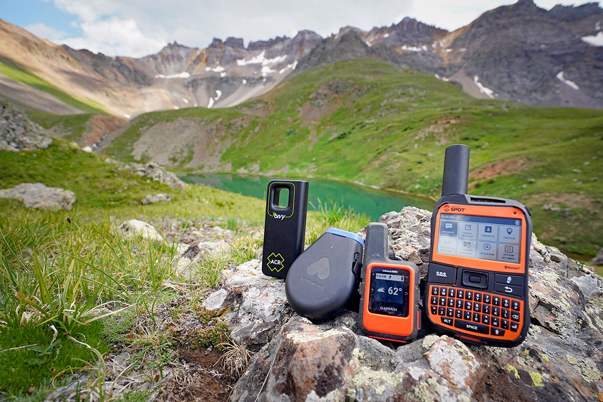 Showing 4 different messenger devices on a rock while high up in the mountains