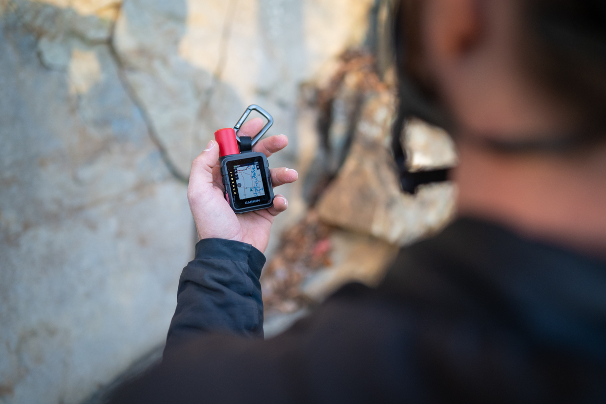 A man holds a Garmin inReach