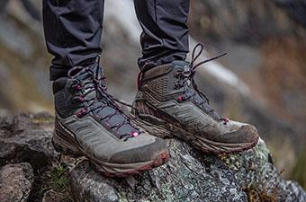 A closeup of the Scarpa Rush TRK GTX hiking boot standing on a rock