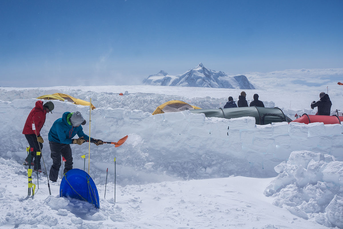 Climbers setting up camp on the snow