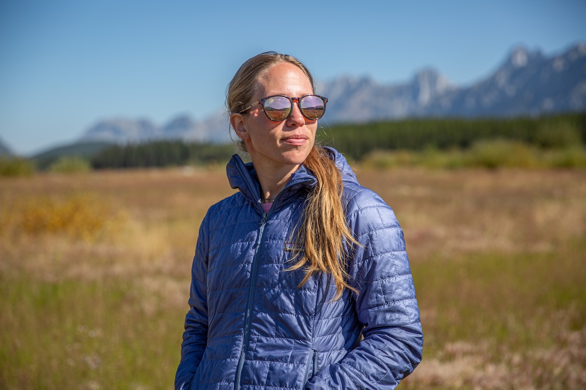 A woman poses with a synthetic jacket