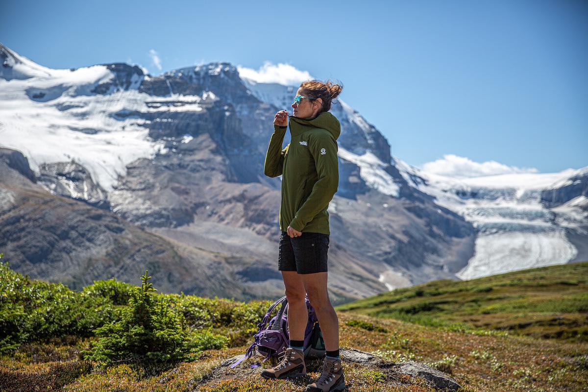 A hiker zips up a synthetic insulated wind layer.