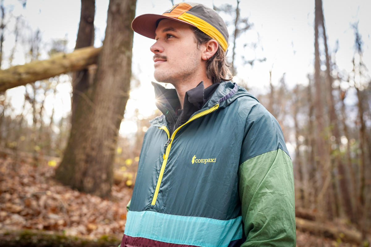 A hiker demonstrates the fit of the Teca windbreaker jacket