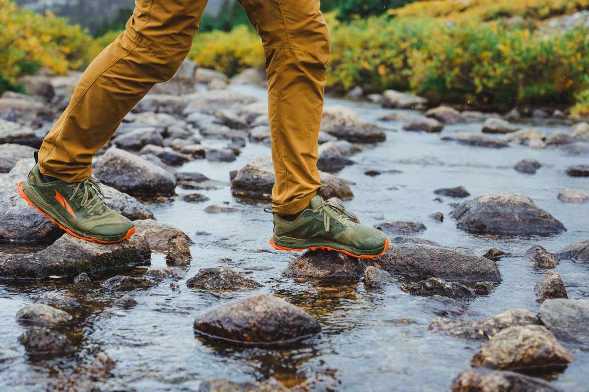 Waterproof shoes rock hopping over a stream