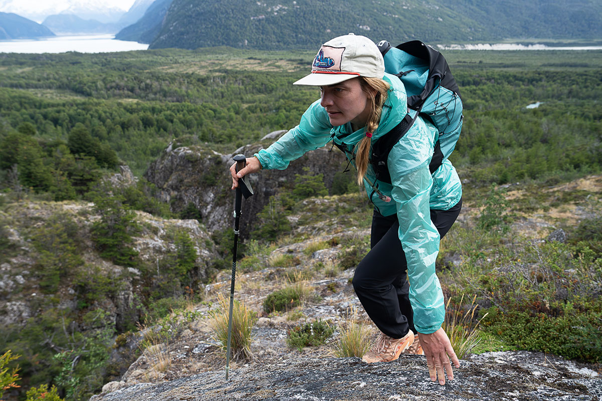 A woman hiking in a blue windbreaker